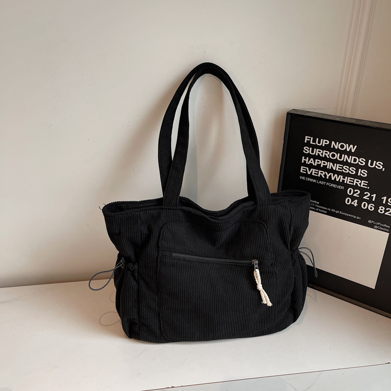 Women's black corduroy tote bag with zipper and slouchy pockets