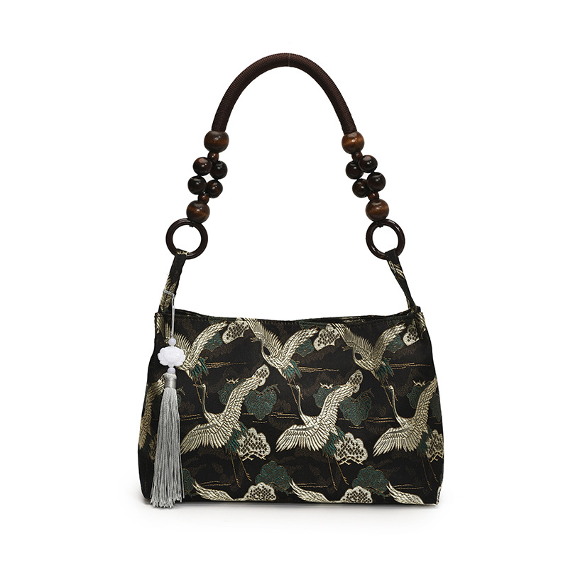 Crane jacquard  black shoulder bag with beaded handle and tassel