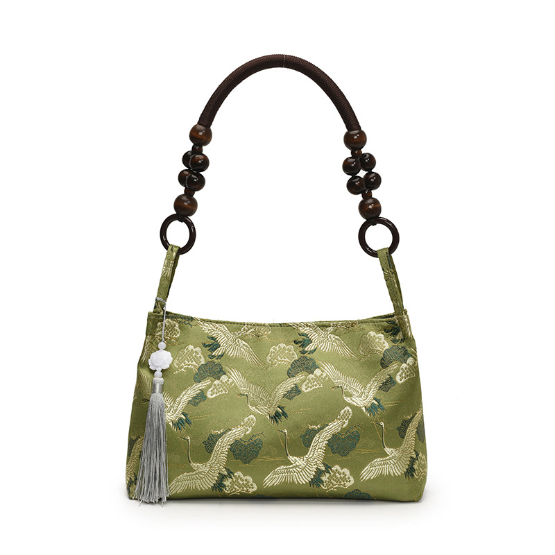 Crane jacquard green shoulder bag with beaded handle and tassel