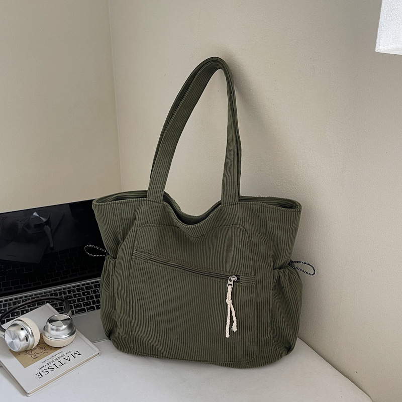 Women's green corduroy tote bag with zipper and slouchy pockets